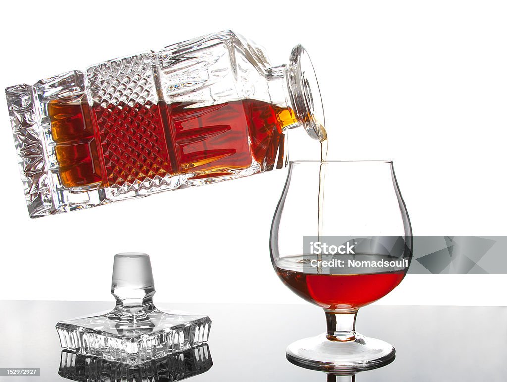 Pouring cognac Pouring cognac from bottle into a glass Alcohol - Drink Stock Photo