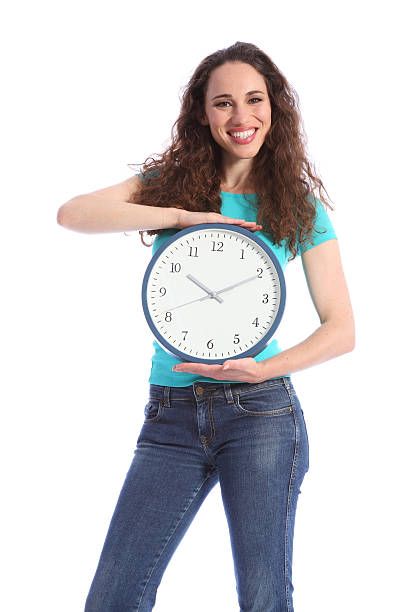 istock Time keeping beautiful young woman holding clock 152973829