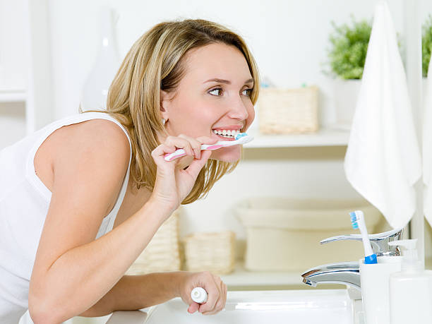 istock Woman cleaning teeth with toothbrush 152974361