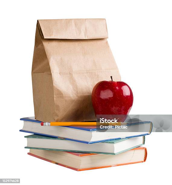 School Lunch On Top Of A Pile Of Books Stock Photo - Download Image Now - School Lunch, Book, Apple - Fruit