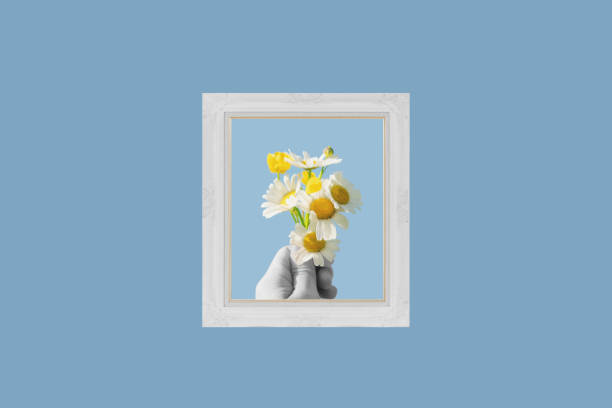 istock Digital collage modern art. Hand holding flowers, in picture frame 1529748096