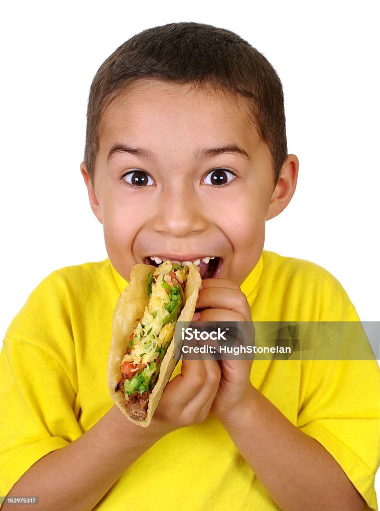 kid with a taco Hispanic boy eating a Mexican taco, isolated on white background Eating Stock Photo