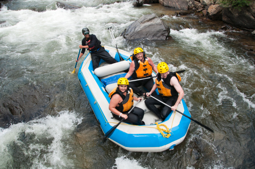 A family white water rafts down the Clear Creek in Colorado.
