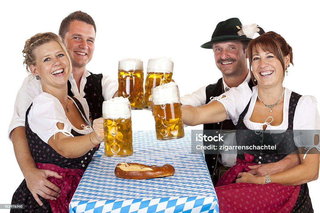 Bavarian men and women toast with Beer Fest beer stein Bavarian men and women toast with Beer Fest beer stein. Isolated on white background. Bavaria Stock Photo