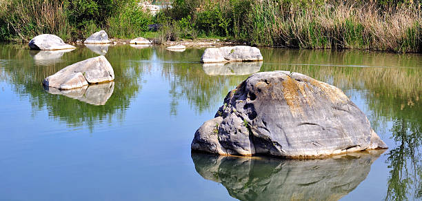 istock rocks scattered in the water 152976406