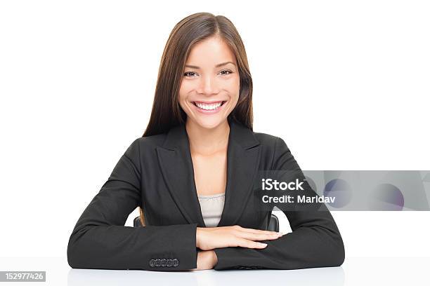 Multiethnic Businesswoman Sitting At Desk Smiling Stock Photo - Download Image Now - White Background, Office, Women