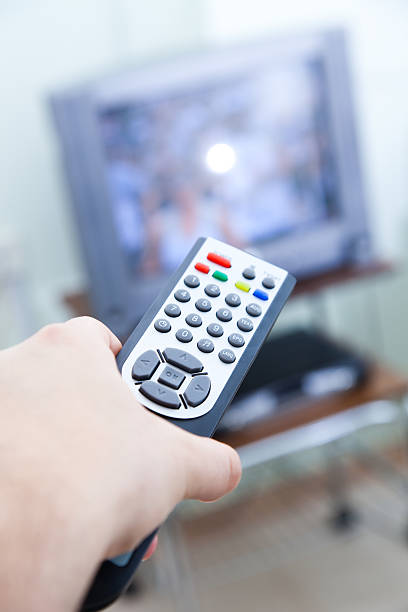istock Hand holding Tv remote and television in background. 152978135