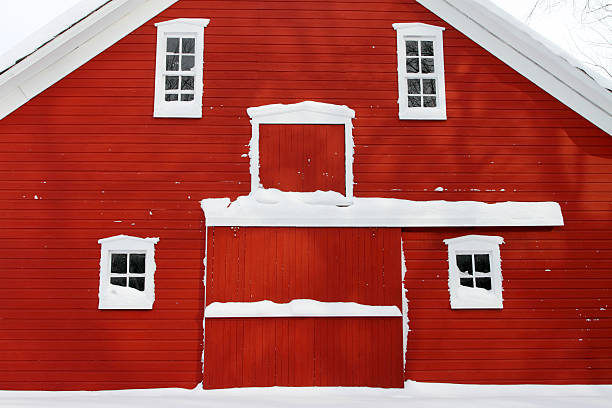 istock facade of red barn in snow 152978386