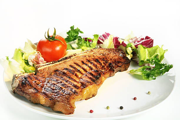 istock Cooked striped boned steak with salad tomato and pepper 152979170