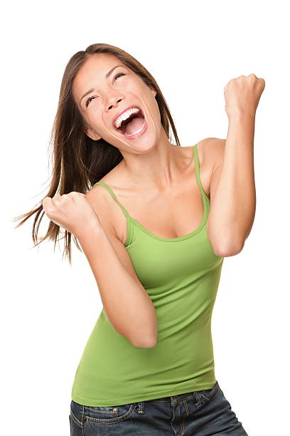 Winner success woman Winning success woman happy ecstatic celebrating being a winner. Dynamic energetic image of multiracial Caucasian Asian female model isolated on white background waist up. For more exhilaration stock pictures, royalty-free photos & images