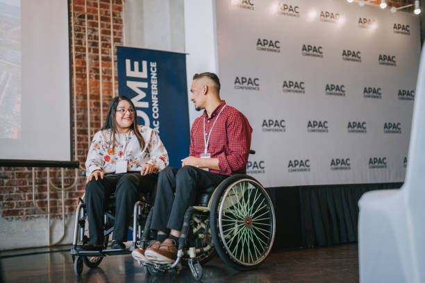 istock 2 Disable Asian Indian white collar workers in wheelchair attending business conference workshop 1529811352