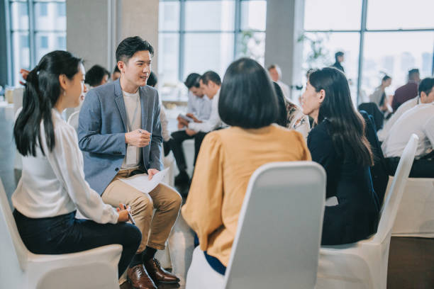 istock Asian workshop participants in small group discussion, brainstorming during business workshop class 1529811828