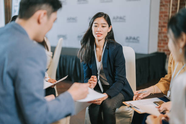 istock Asian workshop participants in small group discussion, brainstorming during business workshop class 1529811830