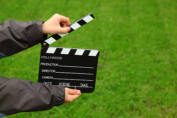 istock Cinema clapper board in hands of boy 152982961