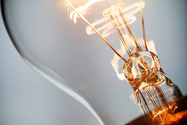 Lightbulb Burning incandescent light bulb filament photos stock pictures, royalty-free photos & images