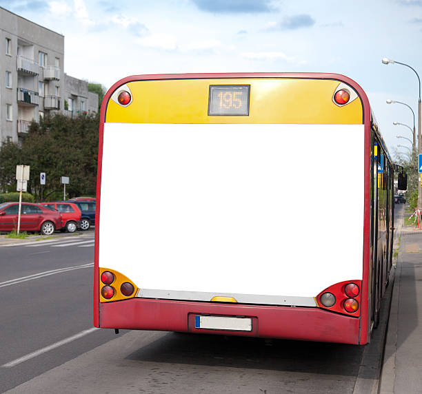 istock Blank white billboard on the back of a yellow and red bus 152985536