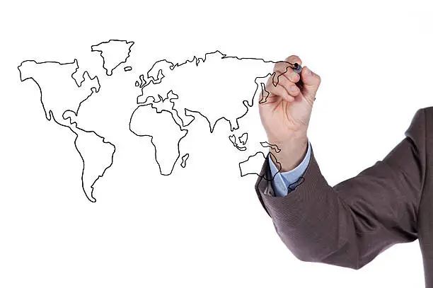 businessman drawing the world map in a whiteboard (selective focus)