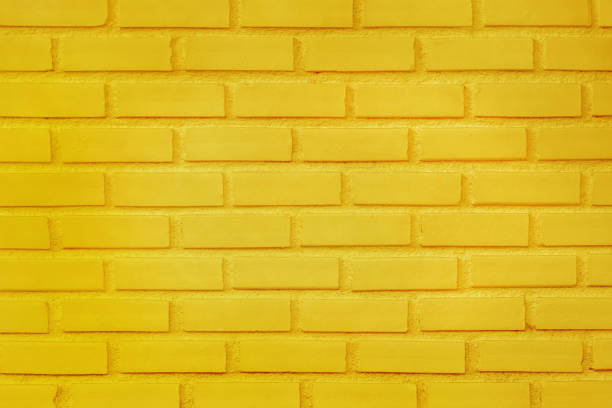 istock Yellow brick wall texture with vintage style pattern for background and design art work. 1529864452