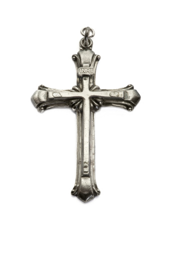 Vintage Sterling Silver Cross isolated on white background.
