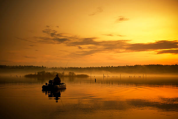 Fisherman in the motorboat stock photo