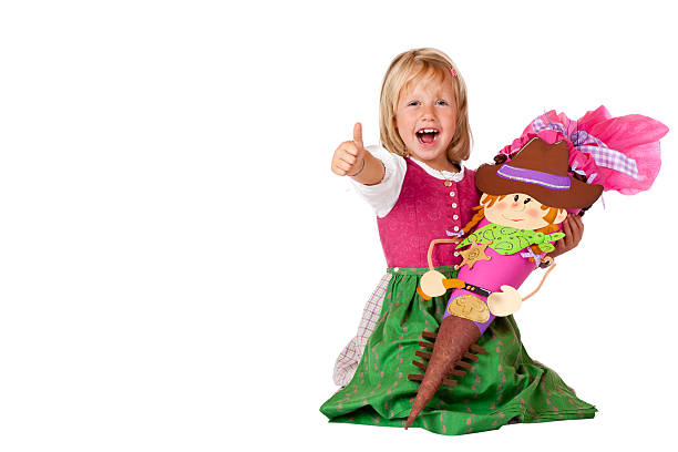 Happy Bavarian girl showing thumb up at first school day stock photo