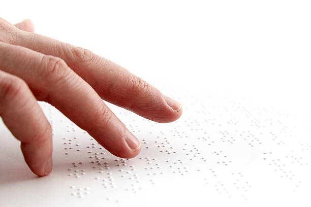 A blind person using their hands to read braille Person reading braille in swedish. assistive technology photos stock pictures, royalty-free photos & images