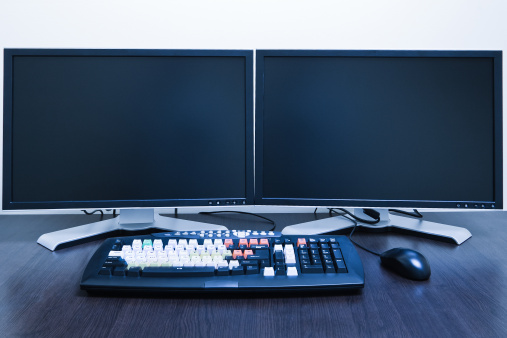 computer workstation with two LCD screens blue toned