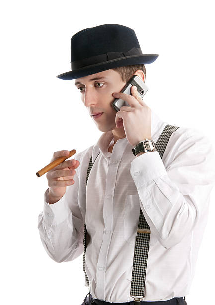 istock young man talks by a mobile phone and holds cigar. 152989520