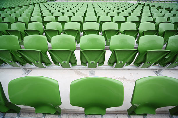 istock green, plastic seats in very big, empty stadium. 152989840