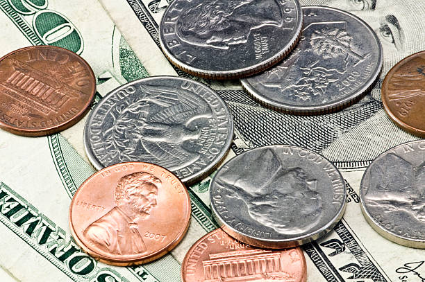 US dollars and coins stock photo