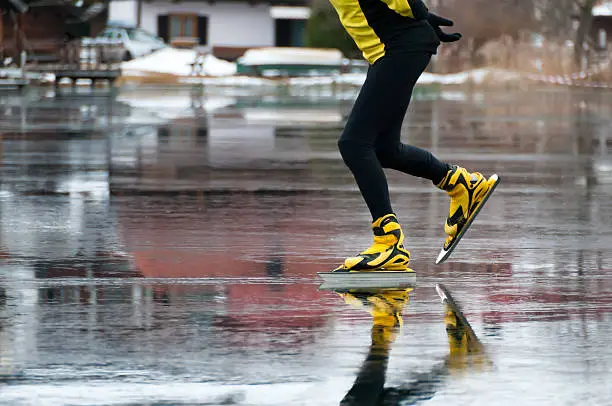 Skater running on the mirror ice