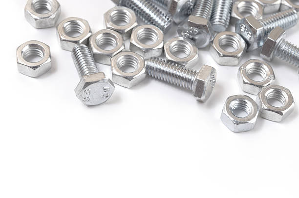 istock Close-up of silver nuts and bolts on a white surface 152991362