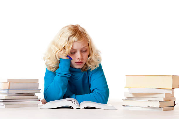 istock Schoolgirl lying on floor doing homework 152991492