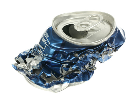 A stock photo of a crushed soda can set against a white background.