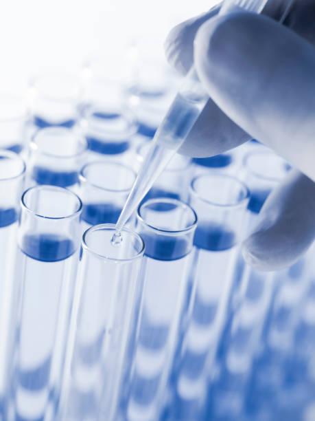 istock Droplet Falling from Pipette into Test Tube. 1529930949