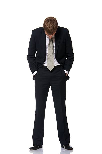 istock Young businessman holding his head down isolated on white 152993655