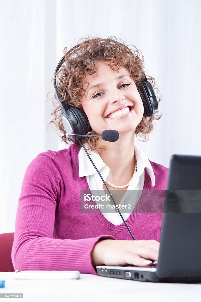 Adorable business woman  working with a laptop Adorable business woman  working at her desk with a laptop Adult Stock Photo