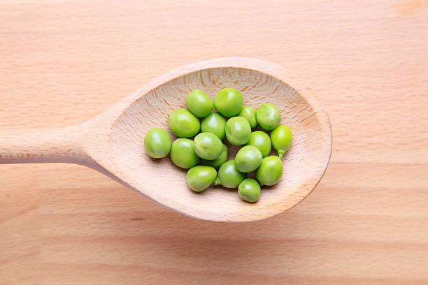 istock Pea in wooden spoon 152994111