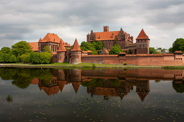 European style red brick castle with turrets and wall Malbork Castle malbork photos stock pictures, royalty-free photos & images