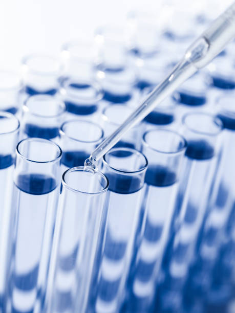 istock Droplet Falling from Pipette into Test Tube. 1529946451