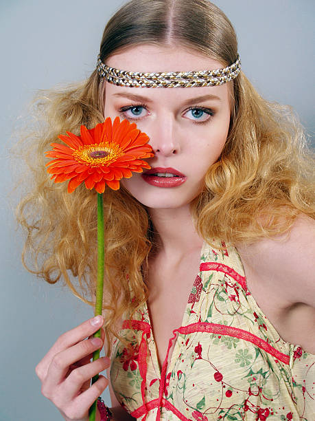 istock beautiful long-haired girl  with a flower 152995100