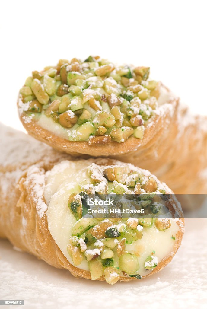 Italian Cannoli on white Delicious Italian Cannoli with pistachio nuts and powdered sugar Baked Stock Photo