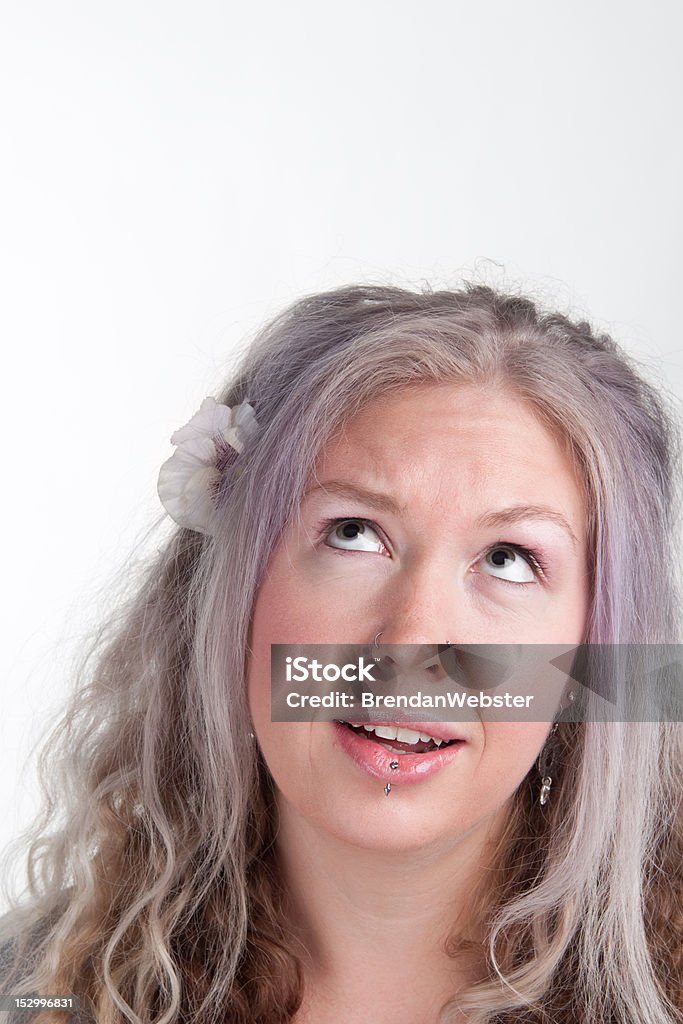 Young woman thinking A portrait of a young woman looking upwards in thought, with copy space. 20-24 Years Stock Photo