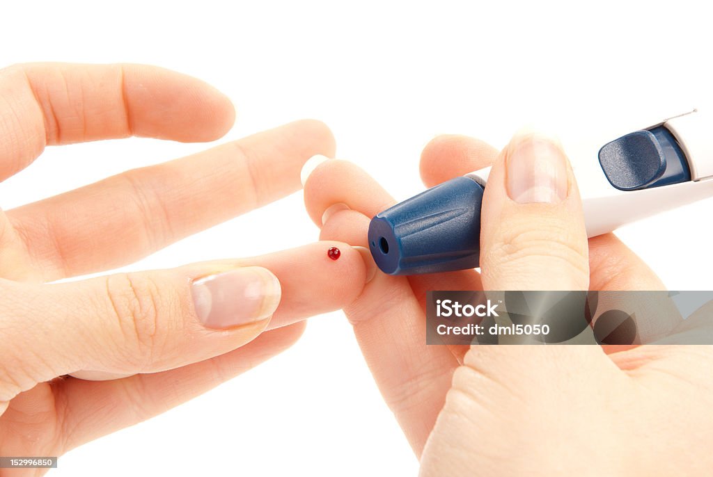 Diabetes lancet in hand prick finger Diabetes lancet in hand prick finger to make punctures to obtain small blood specimens for blood glucose, hemoglobin level test using glucometer isolated on a white background Blood Test Stock Photo