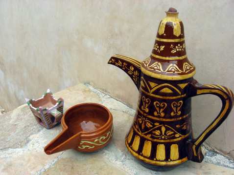 A finjan for making Arabic coffee and cup in Al Hazm Fort in Oman