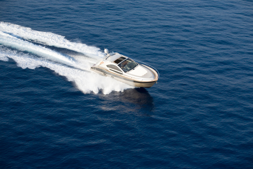 Motor boat floating on clear turquoise water