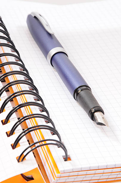 notebook and pen stock photo