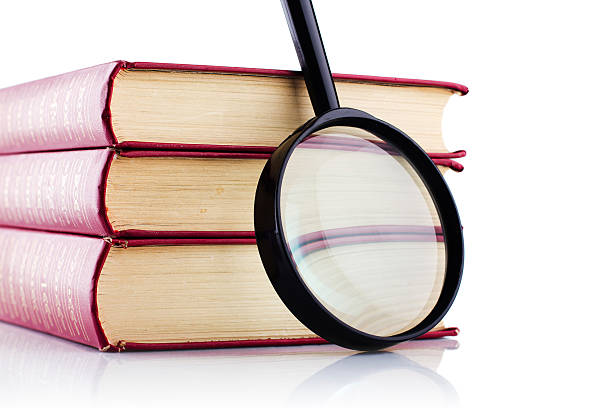 istock Old books with a loupe on white background. Isolated. 152998678