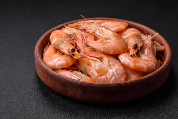 istock Delicious fresh boiled tiger prawns with salt and spices on a ceramic plate 1529996841