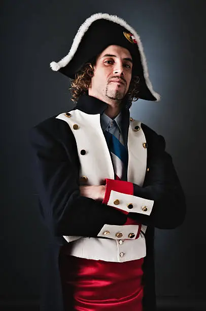 Young adult wearing a Napoleon costume suit.